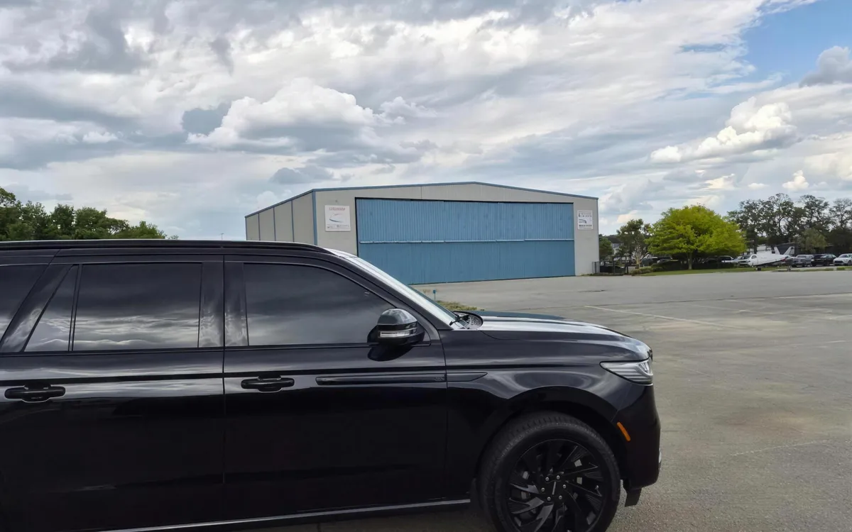 Black Lincoln Navigator L luxury SUV parked and ready for corporate executive chauffeur service.