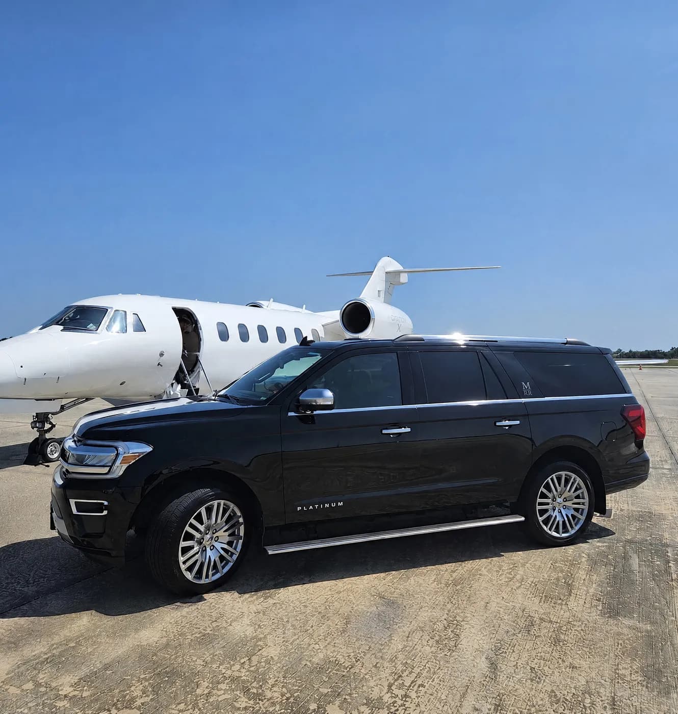 A Minneola Referred Ride Ford Expedition planeside on the tarmac at TIX airport